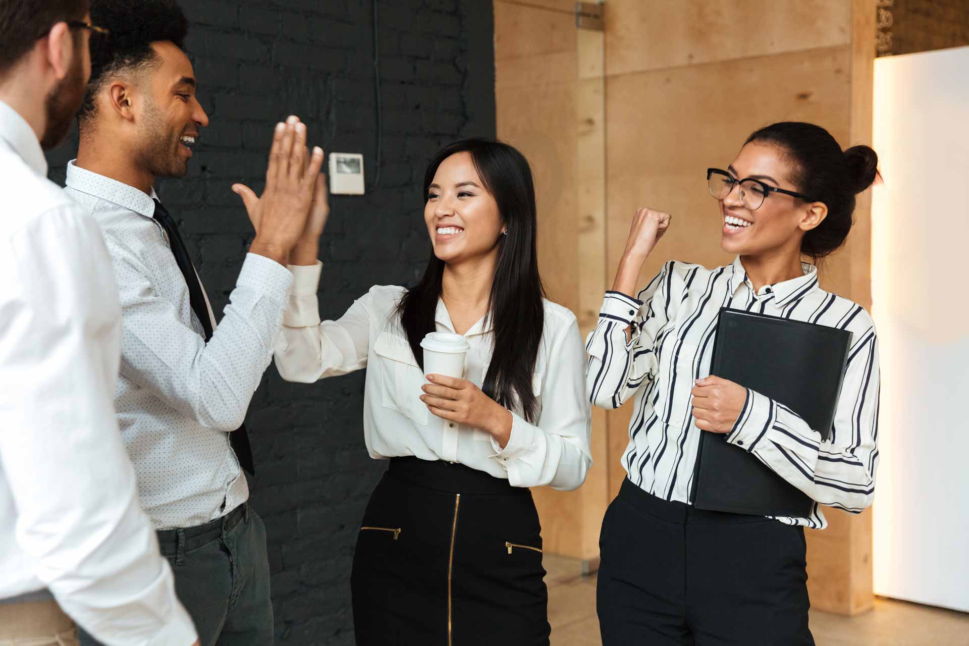 excited-young-business-colleagues-gives-high-five-each-others